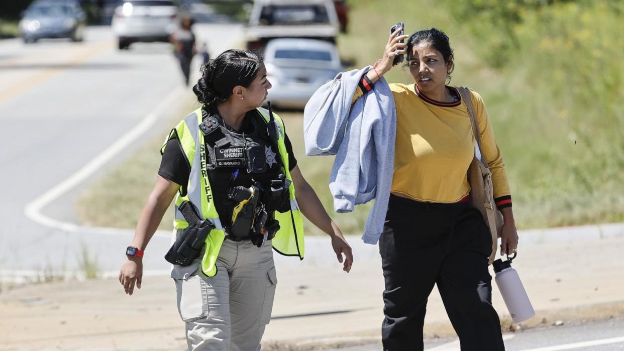 PHOTO: A police officer talks with a woman near the scene of a shooting at Apalachee High School in Winder, Georgia, September 4, 2024. (Erik S Lesser/EPA-EFE/Shutterstock)