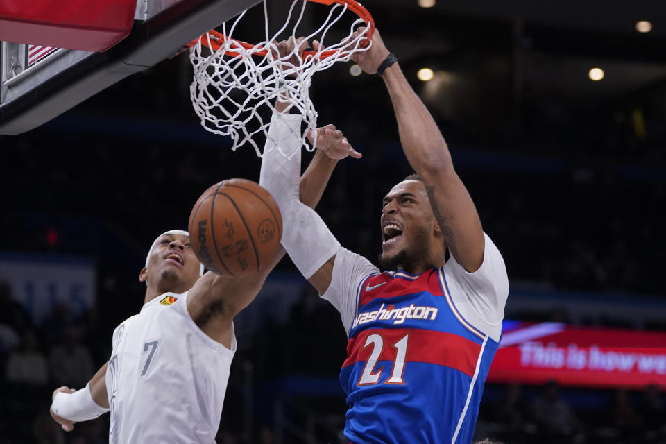 Washington Wizards center Daniel Gafford (21) dunks in front of Oklahoma City Thunder forward Darius Bazley (7) in the first half of an NBA basketball game Friday, Nov. 26, 2021, in Oklahoma City. (AP Photo/Sue Ogrocki)