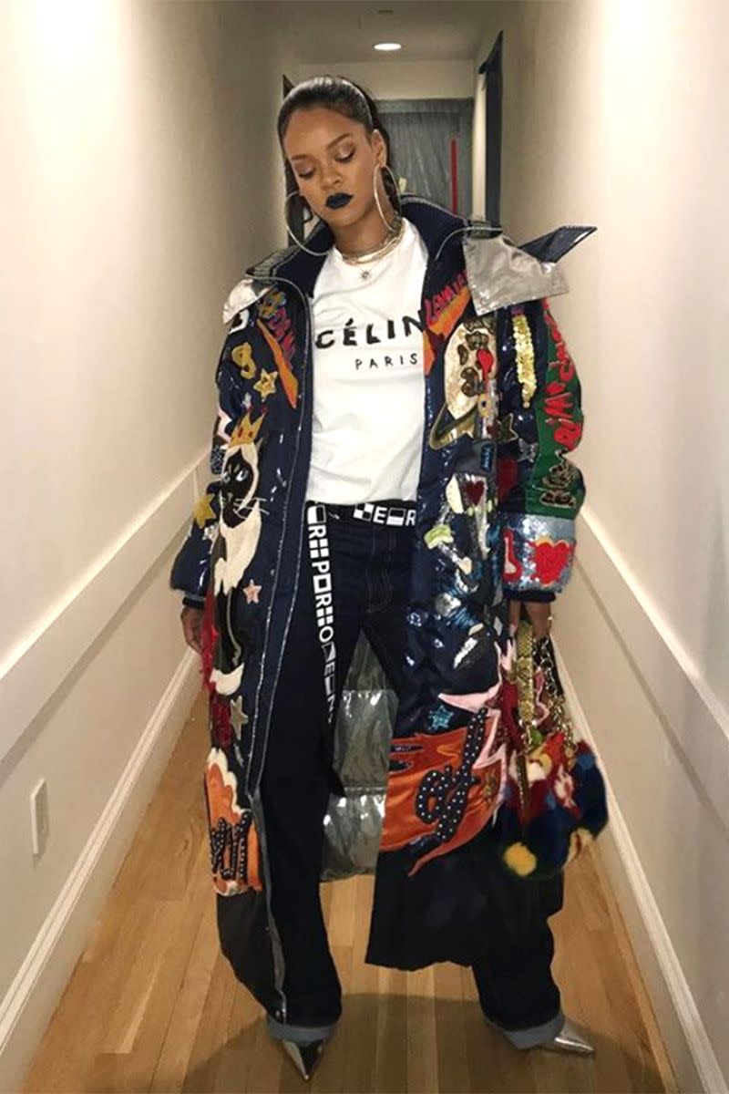 <p>In a Dolce & Gabbana coat, Céline graphic tee, long belt, oversized jeans, silver pumps, large hoop earrings, and <a href="https://www.harpersbazaar.com/beauty/makeup/a14380725/fenty-beauty-rihanna-black-lipstick/" rel="nofollow noopener" target="_blank" data-ylk="slk:black Fenty Beauty lipstick;elm:context_link;itc:0;sec:content-canvas" class="link ">black Fenty Beauty lipstick</a> in an <a href="https://www.instagram.com/p/BcZLB1Wj9DQ/?hl=en&taken-by=badgalriri" rel="nofollow noopener" target="_blank" data-ylk="slk:Instagram photo;elm:context_link;itc:0;sec:content-canvas" class="link ">Instagram photo</a>. </p>