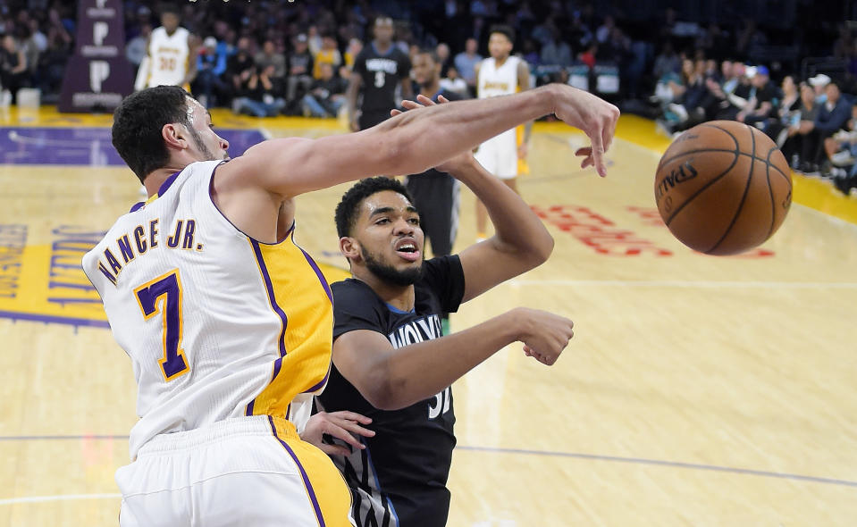 Los Angeles Lakers forward Larry Nance Jr., left, and Minnesota Timberwolves center Karl-Anthony Towns go after a rebound during the first half of an NBA basketball game, Sunday, April 9, 2017, in Los Angeles. (AP Photo/Mark J. Terrill)