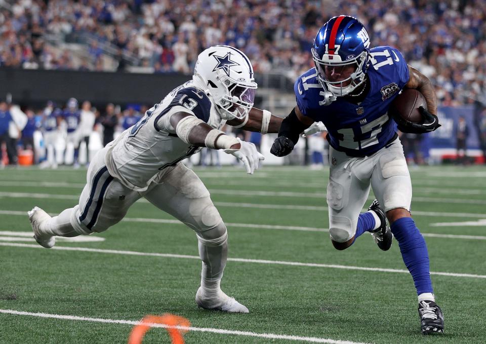 EAST RUTHERFORD, NEW JERSEY – SEPTEMBER 26: Wan'Dale Robinson #17 of the New York Giants carries the ball as DeMarvion Overshown #13 of the Dallas Cowboys attempts a tackle in the third quarter at MetLife Stadium on September 26, 2024 in East Rutherford, New Jersey. (Photo by Sarah Stier/Getty Images)