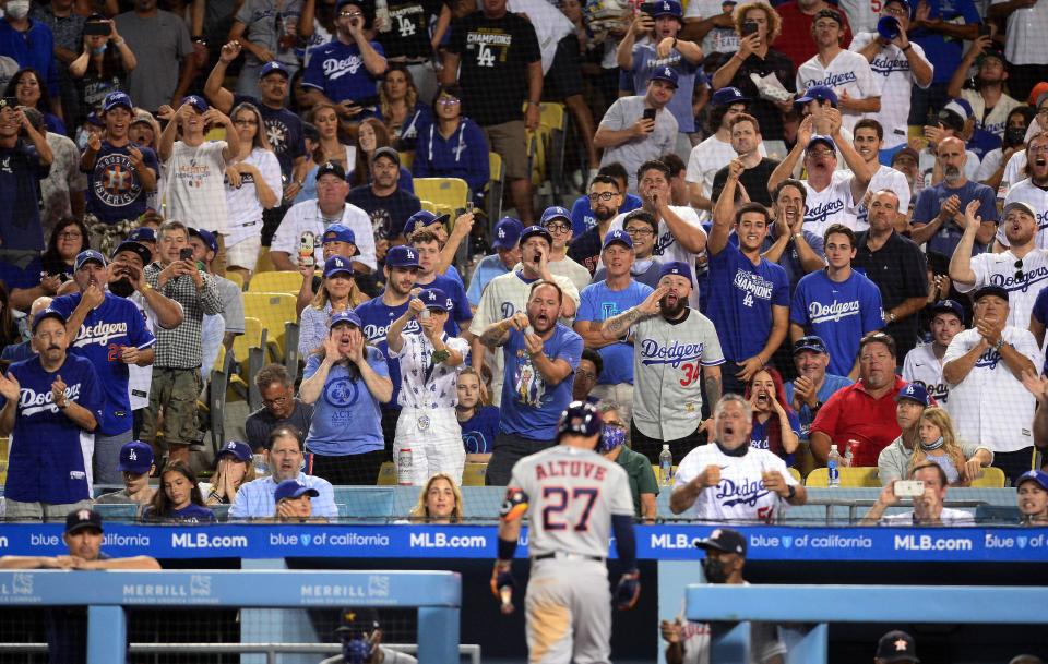 Dodger Stadium spectators react after the Houston Astros' Jose Altuve strikes out during the fifth inning.