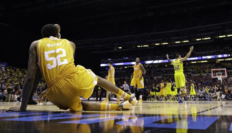 Michigan's Jordan Morgan, right, raises his arms as Tennessee's Jordan McRae gets off the floor after an NCAA Midwest Regional semifinal college basketball tournament game Friday, March 28, 2014, in Indianapolis. Michigan won 73-71.(AP Photo/David J. Phillip)