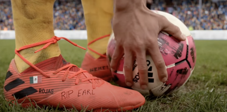 "RIP EARL" written on Dani's cleats with black marker