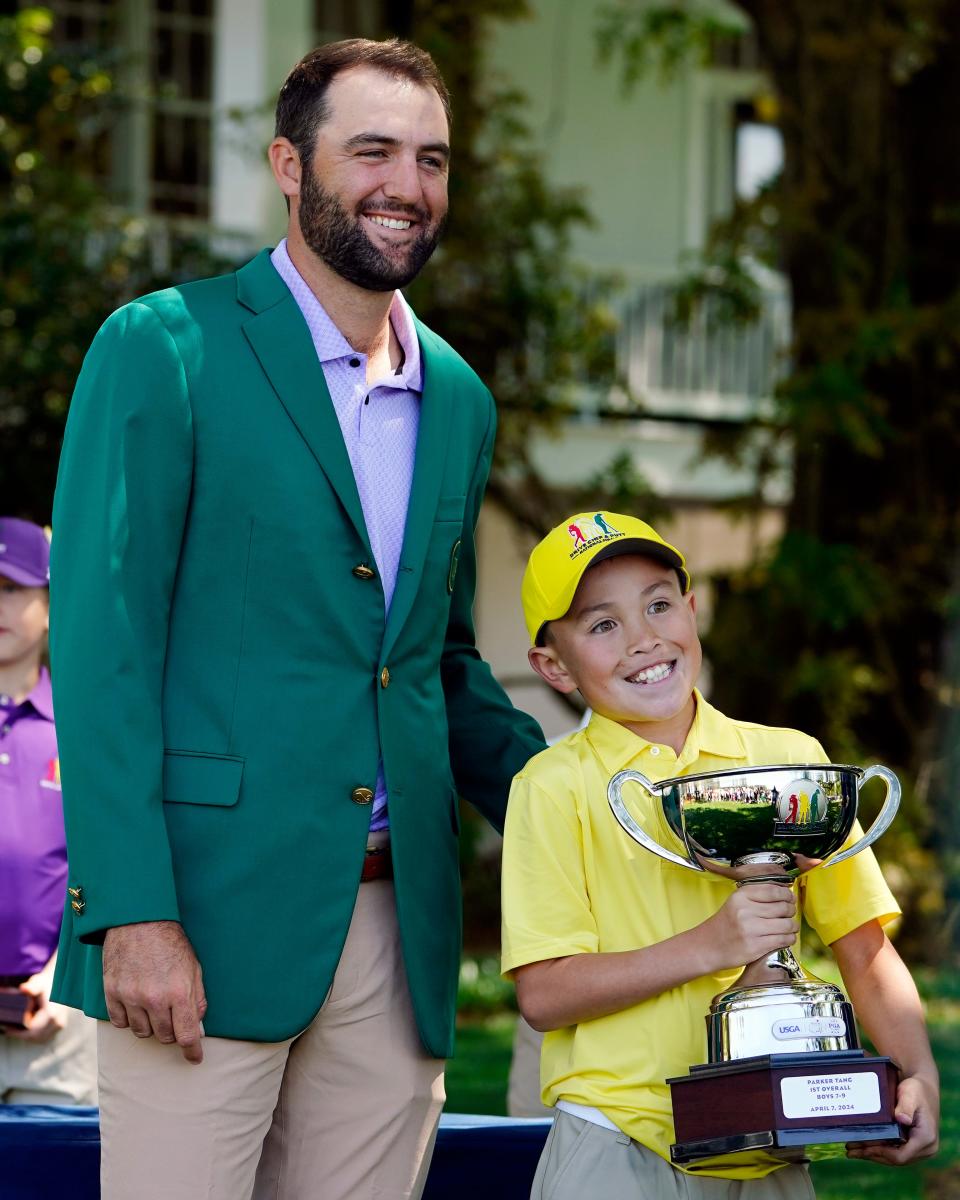 Masters champion Scottie Scheffler poses for a photo with boys 7-9 overall winner Parker Tang from Buckeye, Ariz., during the Drive, Chip & Putt National Finals competition at Augusta National Golf Club.