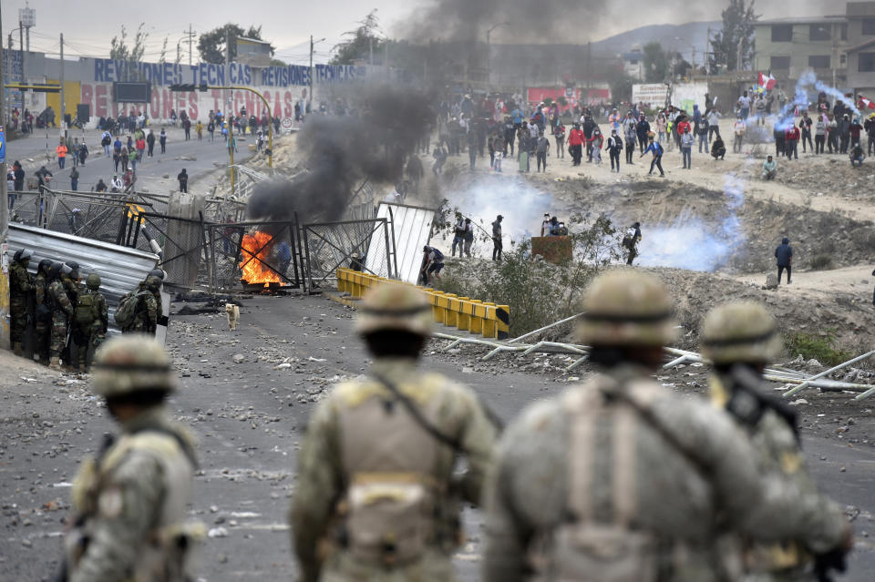 Soldiers clash with anti-government protesters demanding the resignation of President Dina Boluarte, the release from prison of ousted President Pedro Castillo and immediate elections, outside the Alfredo Rodriguez Ballon airport in Arequipa, southern Peru, Friday, Jan. 20, 2023. The daily protests, first largely concentrated in the south have exposed deep divisions in the country between the urban elites and the rural poor. (AP Photo/Jose Sotomayor)