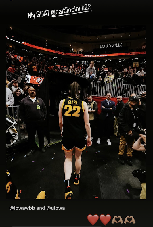 a man in a sports uniform walking on a basketball court