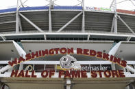 Signs for the Washington Redskins are displayed outside FedEx Field in Landover, Md., Monday, July 13, 2020. The Washington NFL franchise announced Monday that it will drop the "Redskins" name and Indian head logo immediately, bowing to decades of criticism that they are offensive to Native Americans. (AP Photo/Susan Walsh)