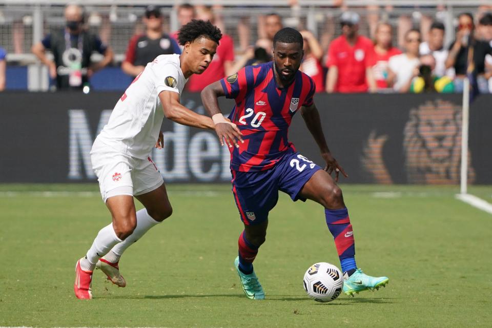 USMNT defender Shaq Moore (20) controls the ball as Canada's Tajon Buchanan defends during Concacaf Gold Cup Soccer group play at Children's Mercy Park in Kansas City.