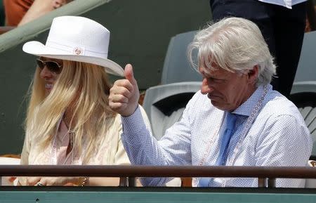 Former tennis player Bjorn Borg (R) and his wife Patricia Ostfeldt watch the men's semi-final match between Jo-Wilfried Tsonga of France and Stan Wawrinka of Switzerland during the French Open tennis tournament at the Roland Garros stadium in Paris, France, June 5, 2015. REUTERS/Jean-Paul Pelissier