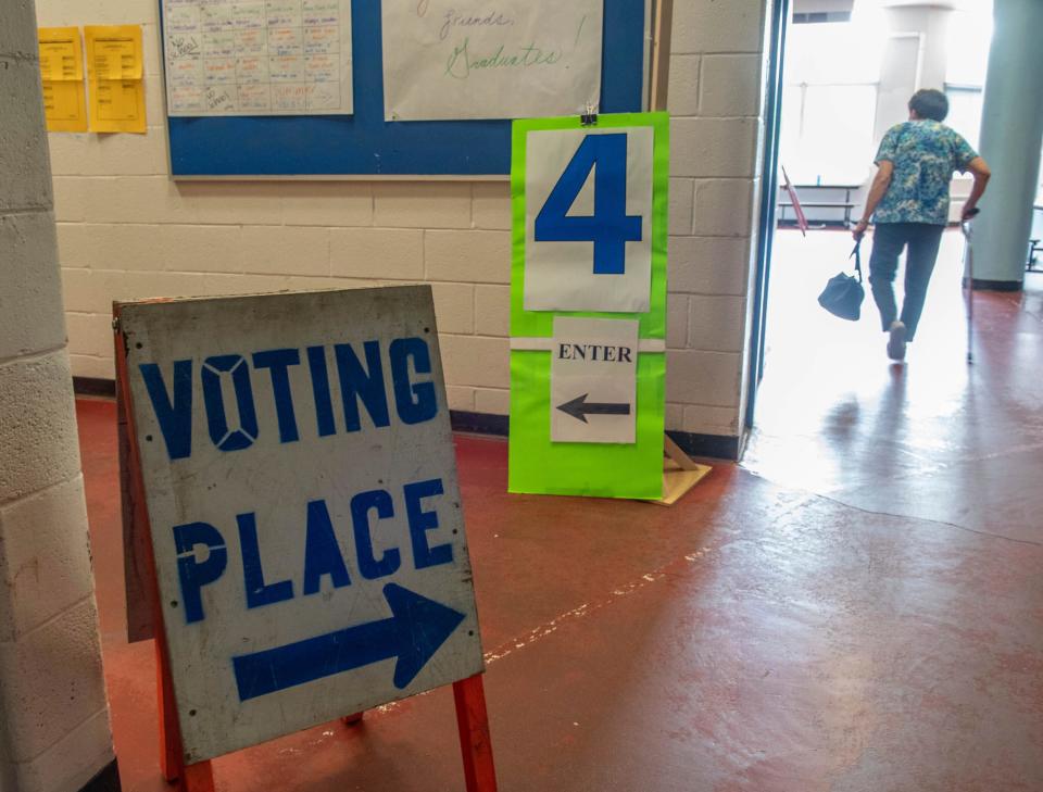 A voter heads down the hallway toward the Ward 5 voting place for the state's primary elections, Tuesday, June 14, 2022, at Longley Elementary School in Lewiston, Maine.