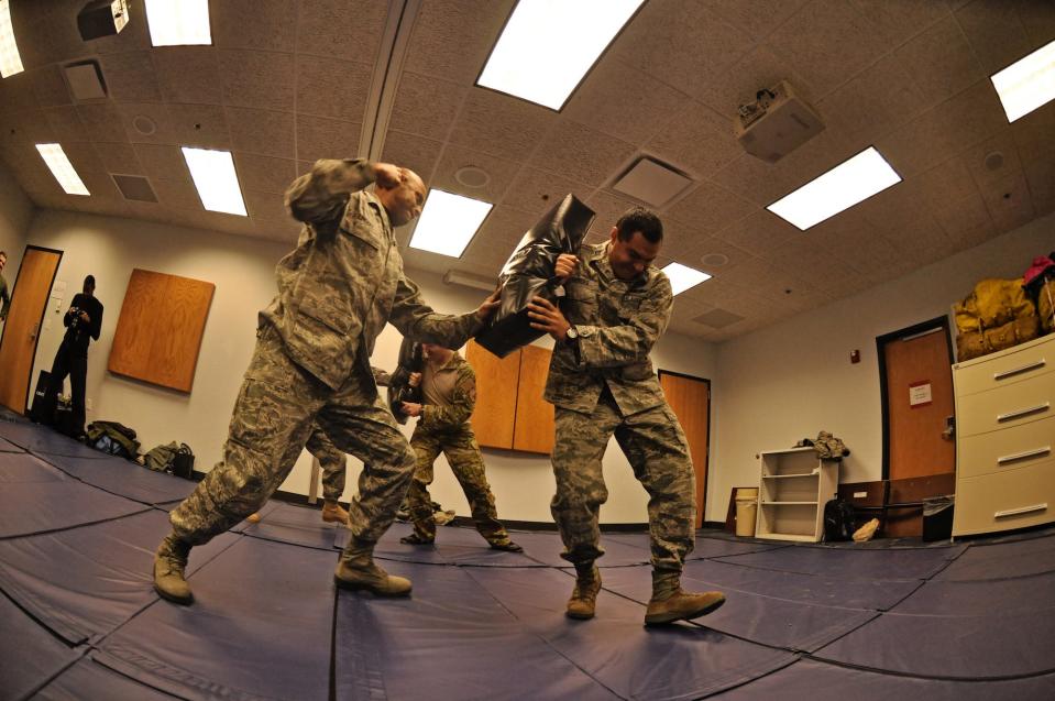 US airmen practice combat during survival, evasion, resistance and escape SERE course