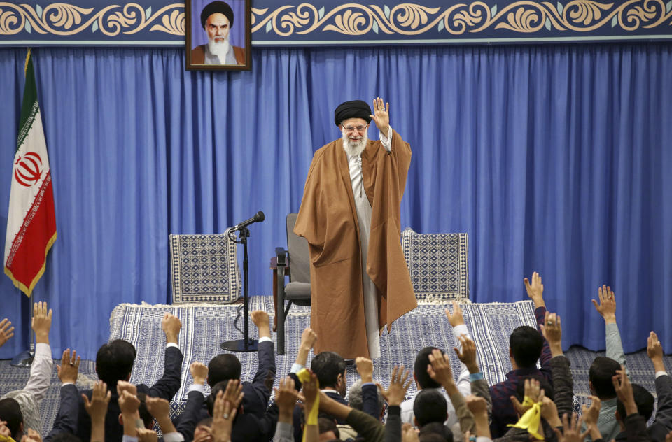 In this picture released by the official website of the office of the Iranian supreme leader, Supreme Leader Ayatollah Ali Khamenei waves to thousands of students as they chant slogan during their meeting in Tehran, Iran, Sunday, Nov. 3, 2019. Khamenei said his country has outmaneuvered the United States in the four decades since the 1979 Islamic Revolution. A portrait of the late revolutionary founder Ayatollah Khomeini hangs above. (Office of the Iranian Supreme Leader via AP)