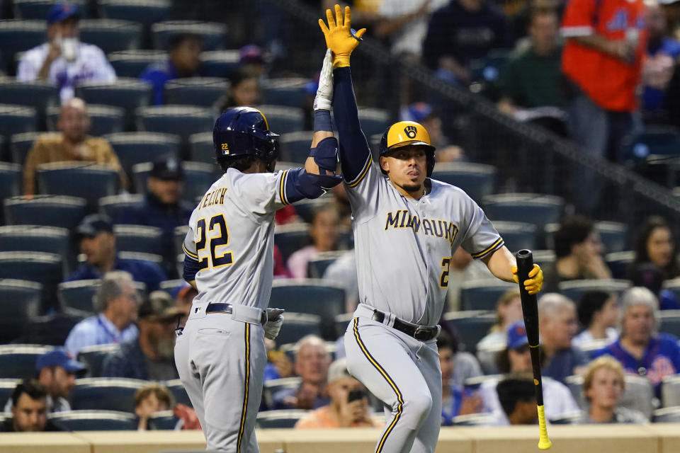 Milwaukee Brewers' Christian Yelich (22) celebrates with Willy Adames, right, after hitting a home run during the fourth inning of the team's baseball game against the New York Mets on Thursday, June 16, 2022, in New York. (AP Photo/Frank Franklin II)