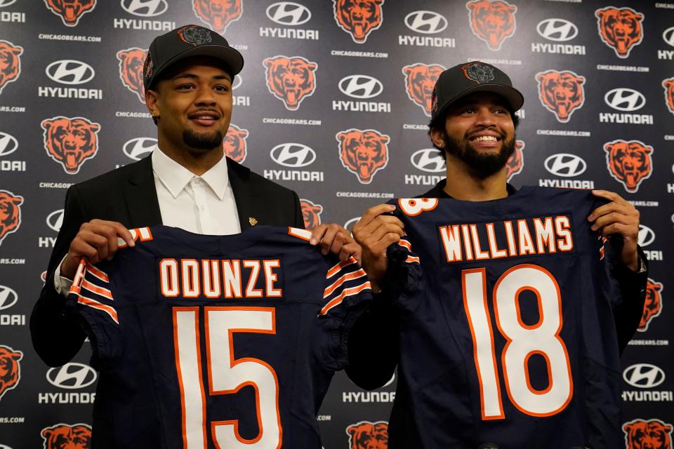 Chicago Bears first-round draft choices receiver Rome Odunze and quarterback Caleb Williams pose for photos at a news conference at Halas Hall, April 26, 2024 in Lake Forest, Illinois.