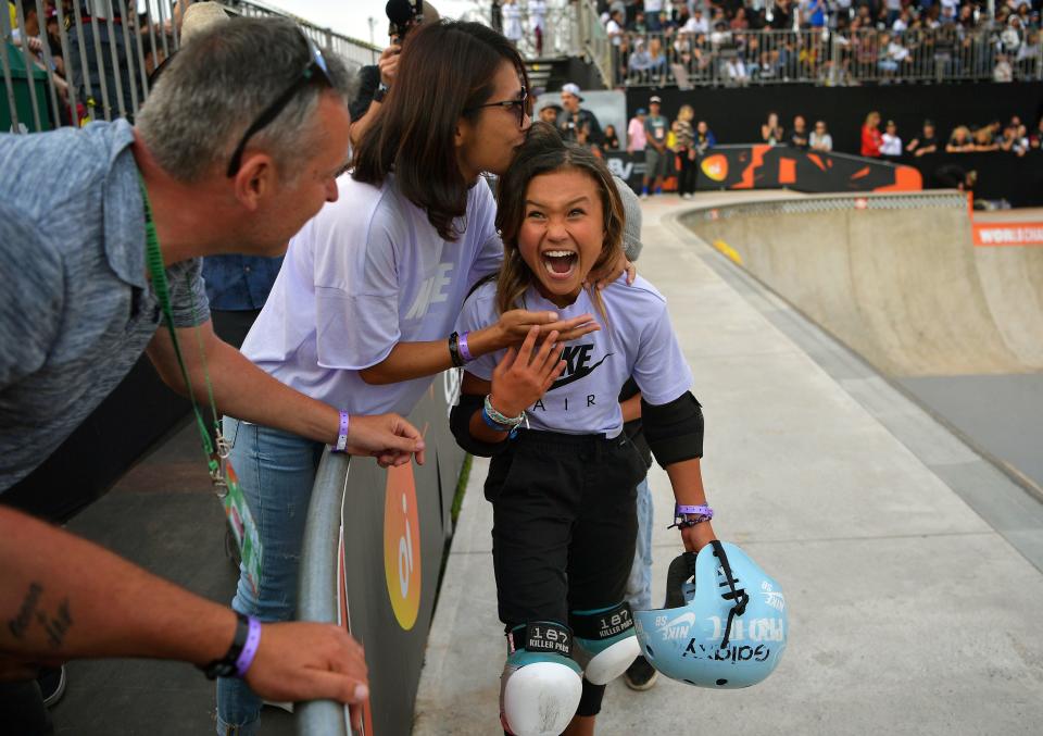 British athlete Sky Brown, 11, reacts as she is kissed by her mother after winning bronze at the World Skateboarding Championships