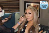 <p>"For the premiere of Season 29, we kept her makeup soft, with a little <em>DWTS</em> glitz of course," says makeup artist <a href="https://www.instagram.com/marylinmakeup/" rel="nofollow noopener" target="_blank" data-ylk="slk:Marylin Lee Spiegel;elm:context_link;itc:0;sec:content-canvas" class="link ">Marylin Lee Spiegel</a>. "A little sparkle on her eyelid using <a href="https://www.smithandcult.com/products/glitterbaby" rel="nofollow noopener" target="_blank" data-ylk="slk:Smith & Cult Glitterbaby metallic-shift eye shadow in Bronze;elm:context_link;itc:0;sec:content-canvas" class="link ">Smith & Cult Glitterbaby metallic-shift eye shadow in Bronze</a>, and a glow on her cheeks using <a href="https://www.hourglasscosmetics.com/products/ambient-lighting-edit-ghost" rel="nofollow noopener" target="_blank" data-ylk="slk:Hourglass Ambient Lighting Edit palette in Ghost;elm:context_link;itc:0;sec:content-canvas" class="link ">Hourglass Ambient Lighting Edit palette in Ghost</a>. Her peachy lips are topped off with <a href="https://www.maccosmetics.com/product/13853/309/products/makeup/lips/lip-gloss/lipglass" rel="nofollow noopener" target="_blank" data-ylk="slk:Mac Lipglass in Good Juju;elm:context_link;itc:0;sec:content-canvas" class="link ">Mac Lipglass in Good Juju</a>."</p>