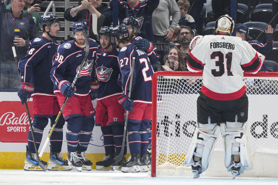 Columbus Blue Jackets' Boone Jenner (38) celebrates with teammates after scoring during the first period of an NHL hockey game against the Ottawa Senators Thursday, March 14, 2024, in Columbus, Ohio. (AP Photo/Jeff Dean)