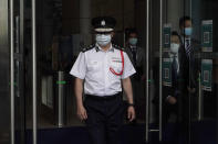Chris Tang, commissioner of the Hong Kong Police Force, arrives for a press conference in Hong Kong, Wednesday, May 12, 2021. A top Hong Kong national security officer was reportedly caught up in a raid on an unlicensed massage business, and will face a police force investigation into the alleged misconduct. Hong Kong’s Director of National Security Frederic Choi has since been put on leave after the incident, according to Tang. (AP Photo/Kin Cheung)