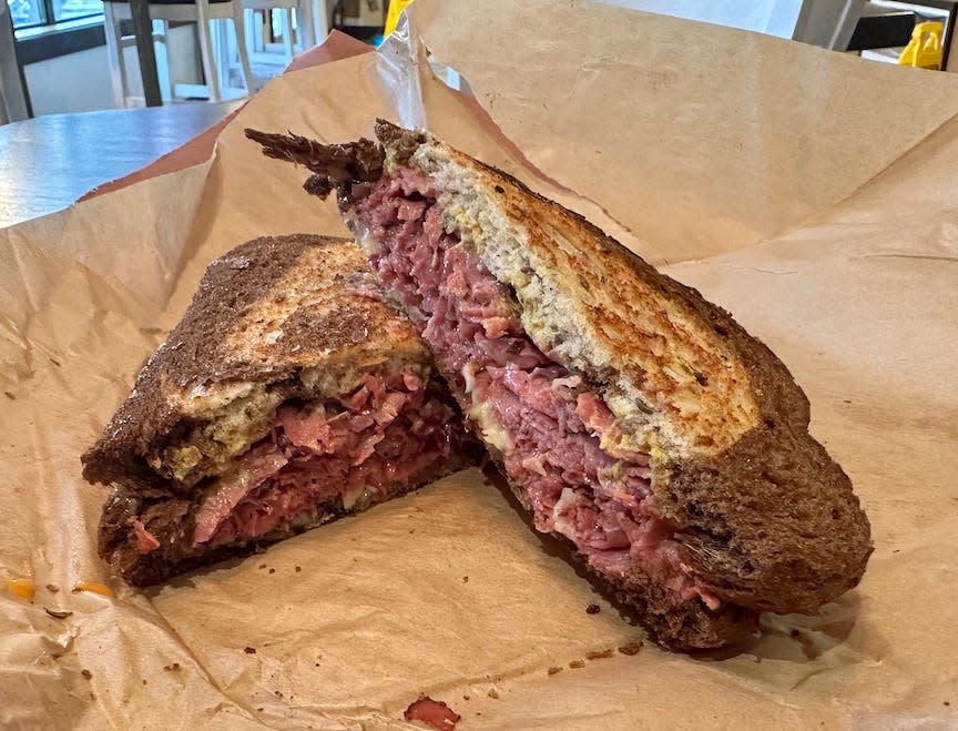 "The Brooklyn Bombers aka Fuhgeddaboudit" from The Paper Bag, 5750 SW 75th Court, Gainesville, is made with homemade corned beef, braised cabbage, homemade Russian dressing, stone-ground mustard and aged Swiss cheese on marbled rye bread.