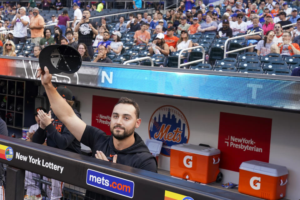 San Francisco Giants right fielder and former New York Mets player Michael Conforto acknowledges the fans' applause as he is introduced on the large television, before a baseball game Friday, June 30, 2023, in New York. (AP Photo/Mary Altaffer)