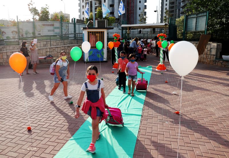Pupils, wearing protective face masks, arrive at their school as Israel reopens first to fourth grades, continuing to ease a second nationwide coronavirus disease (COVID-19) lockdown, at a school in Rehovot