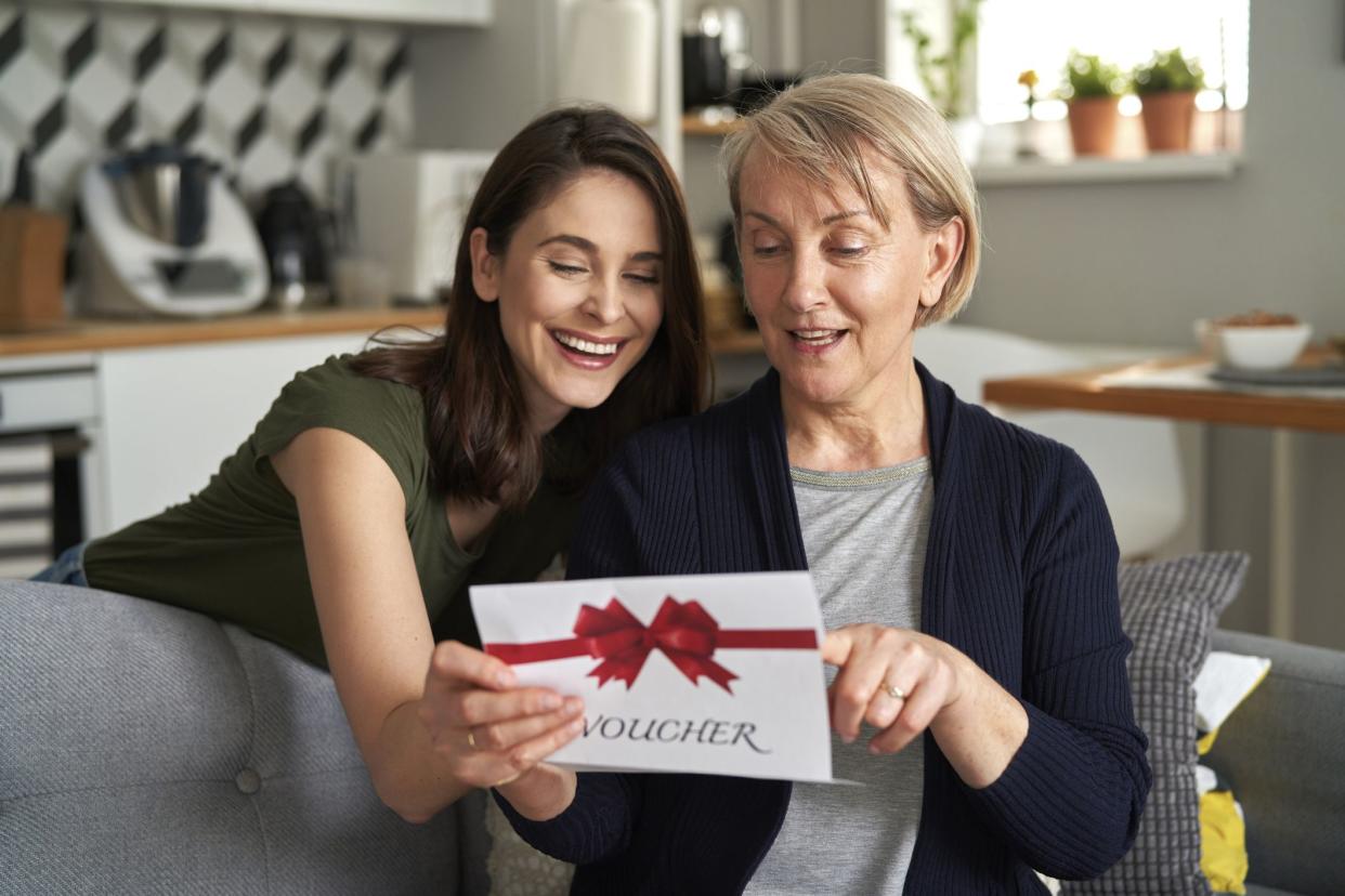 Happy mother reading card from daughter