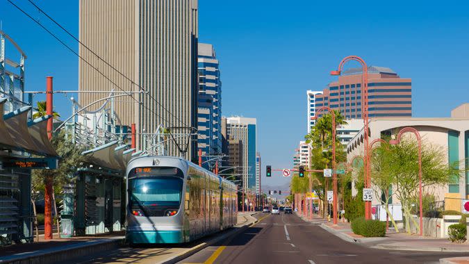 Midtown Phoenix business district with a light rail line and train in the foreground.