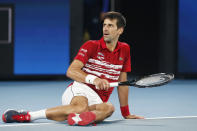 Novak Djovovic of Serbia falls on court after missing a shot against Rafael Nadal of Spain during their ATP Cup tennis match in Sydney, Sunday, Jan. 12, 2020. Djovovic went on to win the match. (AP Photo/Steve Christo)