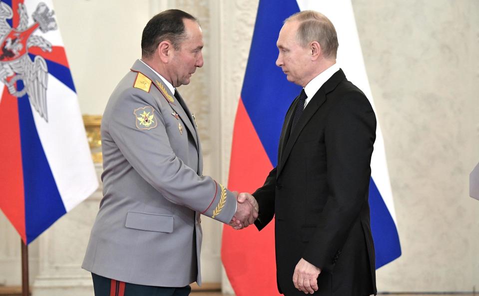 Moscow, Russia. 28th Dec, 2017. Russian President Vladimir Putin congratulates Major General Gennady Zhidko after awarding him the title of the Hero of the Russian Federation at the State Kremlin Palace December 28, 2017 in Moscow, Russia. Putin meet with service members and presented awards for their service in fighting the Islamic State in Syria. Credit: Planetpix/Alamy Live News