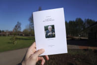 A view of the Order of Service for the funeral of Captain Tom Moore at Bedford Crematorium, in Bedford, England, Saturday, Feb. 27, 2021. Tom Moore, the 100-year-old World War II veteran who captivated the British public in the early days of the coronavirus pandemic with his fundraising efforts died, Tuesday Feb. 2, 2021. (Joe Giddens/Pool Photo via AP)