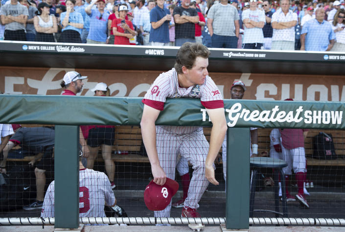 Oklahoma closing pitcher Trevin Michael watches as Mississippi players celebrate their win in Game 2 of the NCAA College World Series baseball finals, Sunday, June 26, 2022, in Omaha, Neb. (AP Photo/Rebecca S. Gratz)