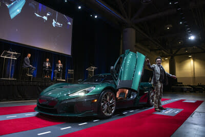 Rimac Nevera hypercar drives on stage during a press event at the Canadian International Auto Show on February 15, 2024.  (CNW Group/Grand Touring Automobiles)