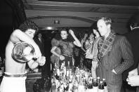 <p>Guests at Studio 54 wait in line for a shirtless bartender to make them a drink from the club's fully stocked back bar.</p>