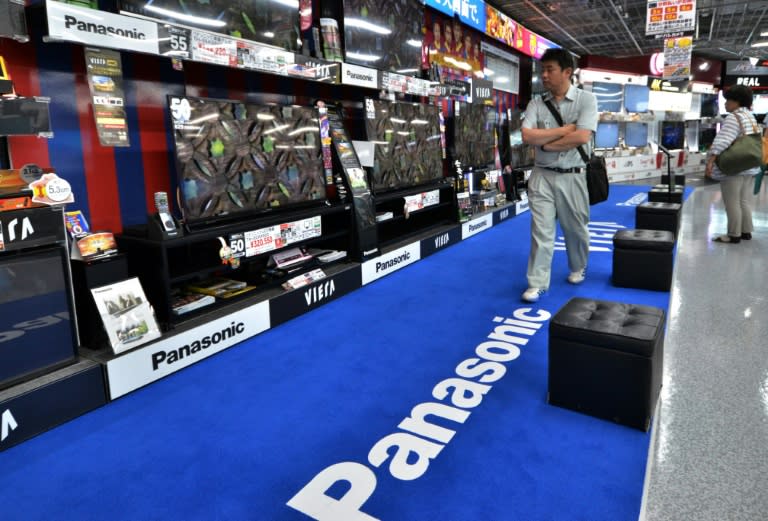 Customers check Panasonic LCD television sets at a store in Tokyo on July 31, 2014