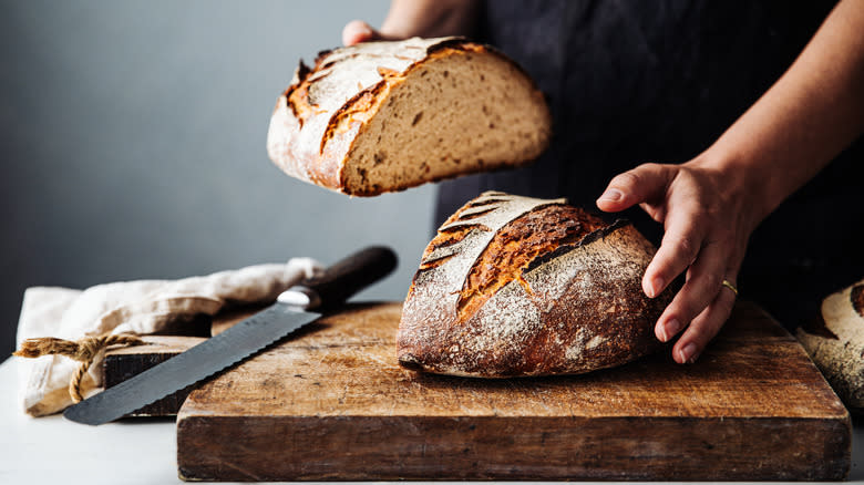 Cutting sourdough bread on board