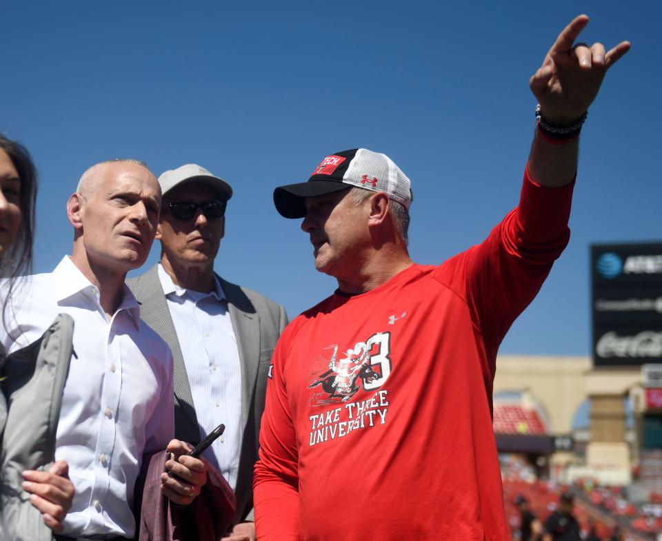 Big 12 commissioner Brett Yormark, left, speaks with Texas Tech's head coach Joey McGuire before the game against Texas, Saturday, Sept. 24, 2022, at Jones AT&T Stadium.