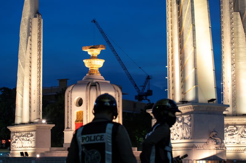 Police officers are seen next to the Democracy monument in Bangkok