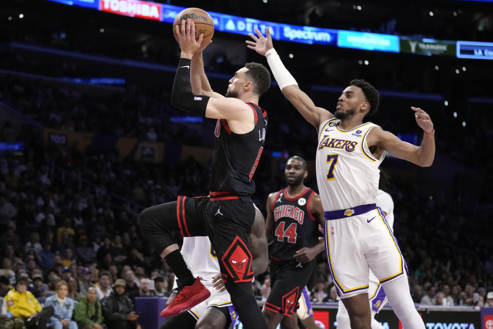 Chicago Bulls guard Zach LaVine (8) shoots past Los Angeles Lakers forward Troy Brown Jr. (7) during the first half of an NBA basketball game Sunday, March 26, 2023, in Los Angeles. (AP Photo/Marcio Jose Sanchez)