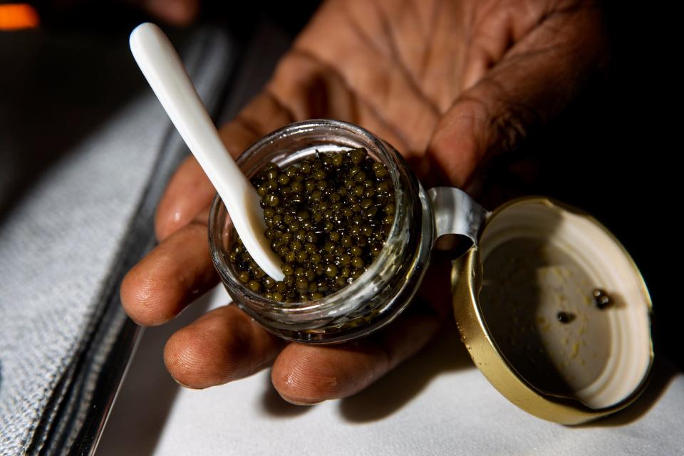 Chef Andy Hyde handles caviar for a dish, Thursday, Nov. 21, 2019, at Hyde N Chic restaurant in Naples.