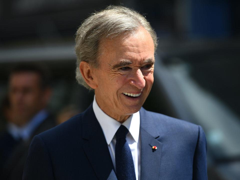 LVMH CEO Bernard Arnault smiles while standing outside