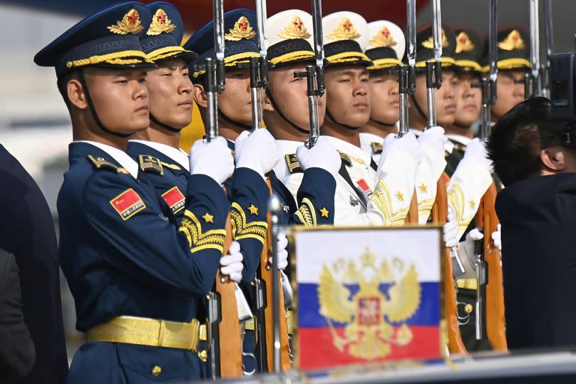 Chinese honor guards stand at attention during the arrival of Russia's President Vladimir Putin at Beijing Capital International Airport, October 2023