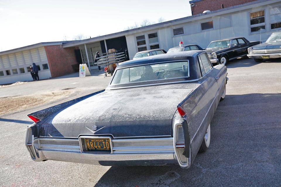 A 1960s-era Cadillac is parked at the closed Foster School in Braintree for filming of "Boston Strangler" on Thursday, Jan. 27, 2022.
