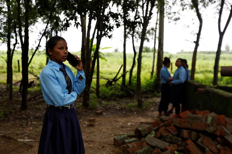 The Wider Image: Nepali woman's quest to learn takes her back to school with son