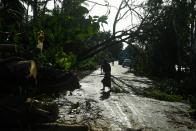 A woman removes debris from a road after the landfall of cyclone Amphan in Midnapore, West Bengal, on May 21, 2020. (Photo by DIBYANGSHU SARKAR/AFP via Getty Images)