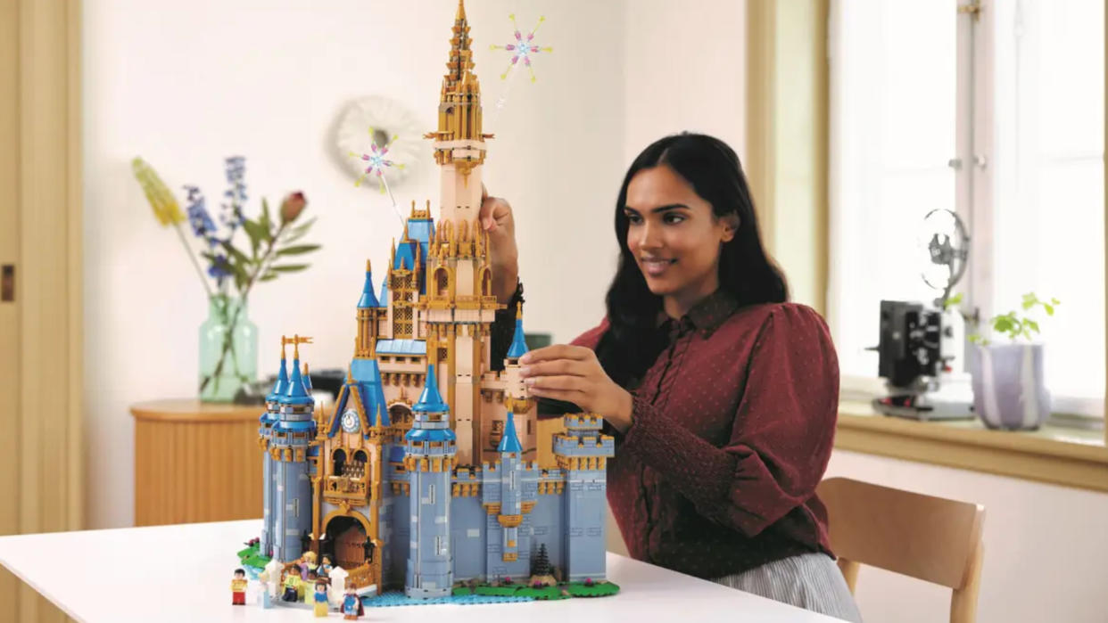  A woman puts the finishing touches to the Lego Disney Castle 