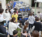 <p>People gather to receive clean drinking water delivered from a special vehicle after an earthquake hit Takatsuki city, Osaka, western Japan, Monday, June 18, 2018. (Photo: Keiji Uesho/Kyodo News via AP) </p>