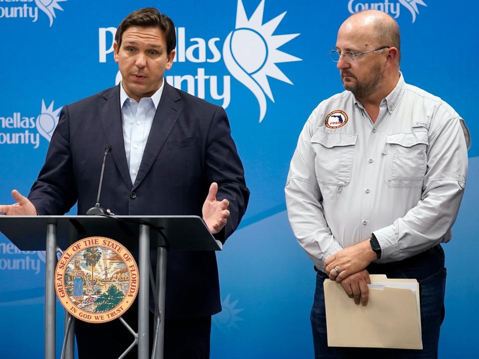 Florida Gov. Ron DeSantis, left, speaks as he stands with Kevin Guthrie, director of the Florida Division of Emergency Management, during a news conference, Monday, Sept. 26, 2022, in Largo, Florida.