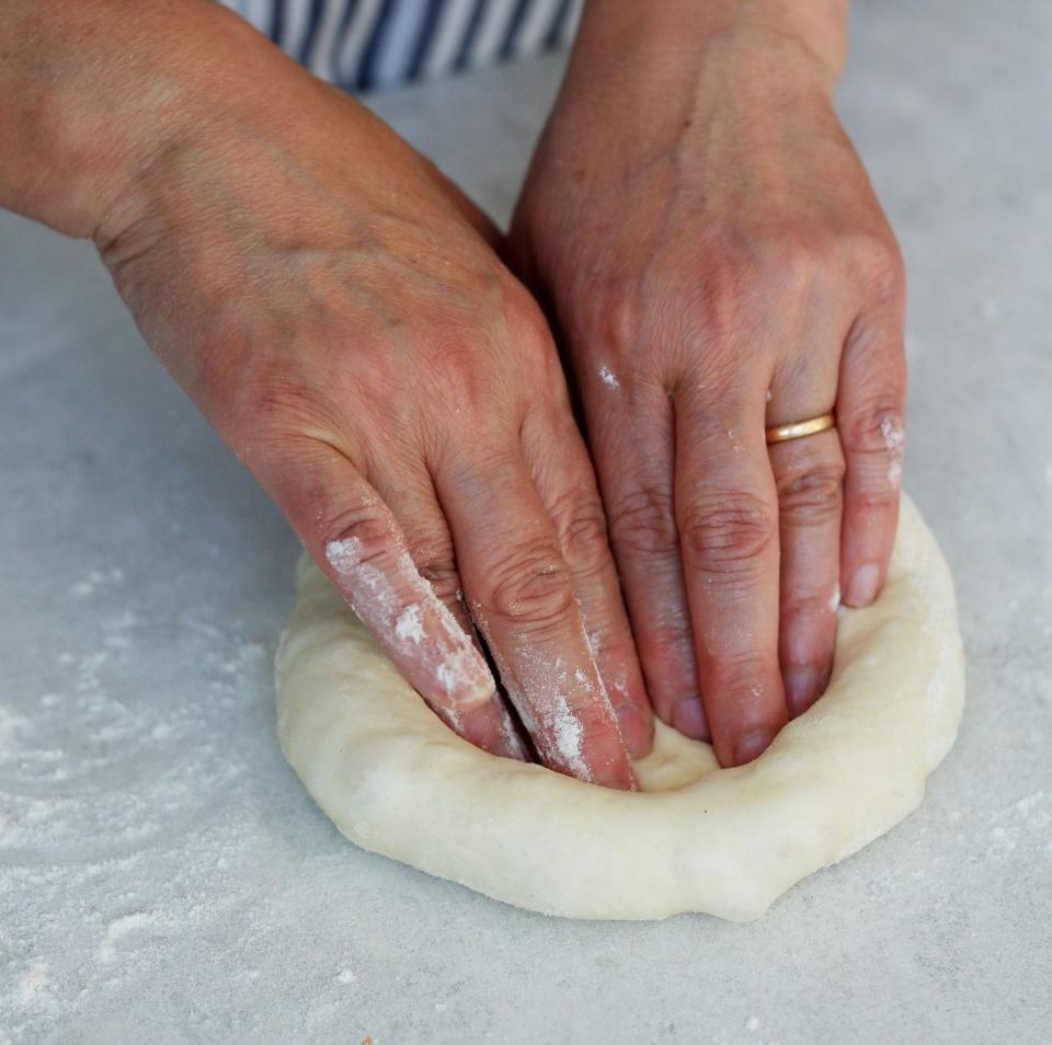 Hands of food writer Silvana Franco as she makes a pizza base at her house in Surrey - Clara Molden for The Daily Telegraph