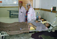 A man injured in a bus accident in Dana Sar, Khyber Pakhtunkhwa province, is treated at a hospital in Quetta, Pakistan, Sunday, July 3, 2022. An official said the passenger bus slid off a mountain road and fell 200 feet (61 meters) into a ravine in heavy rain killing at least 18 people and injuring some 12 others. (AP Photo/Arshad Butt)